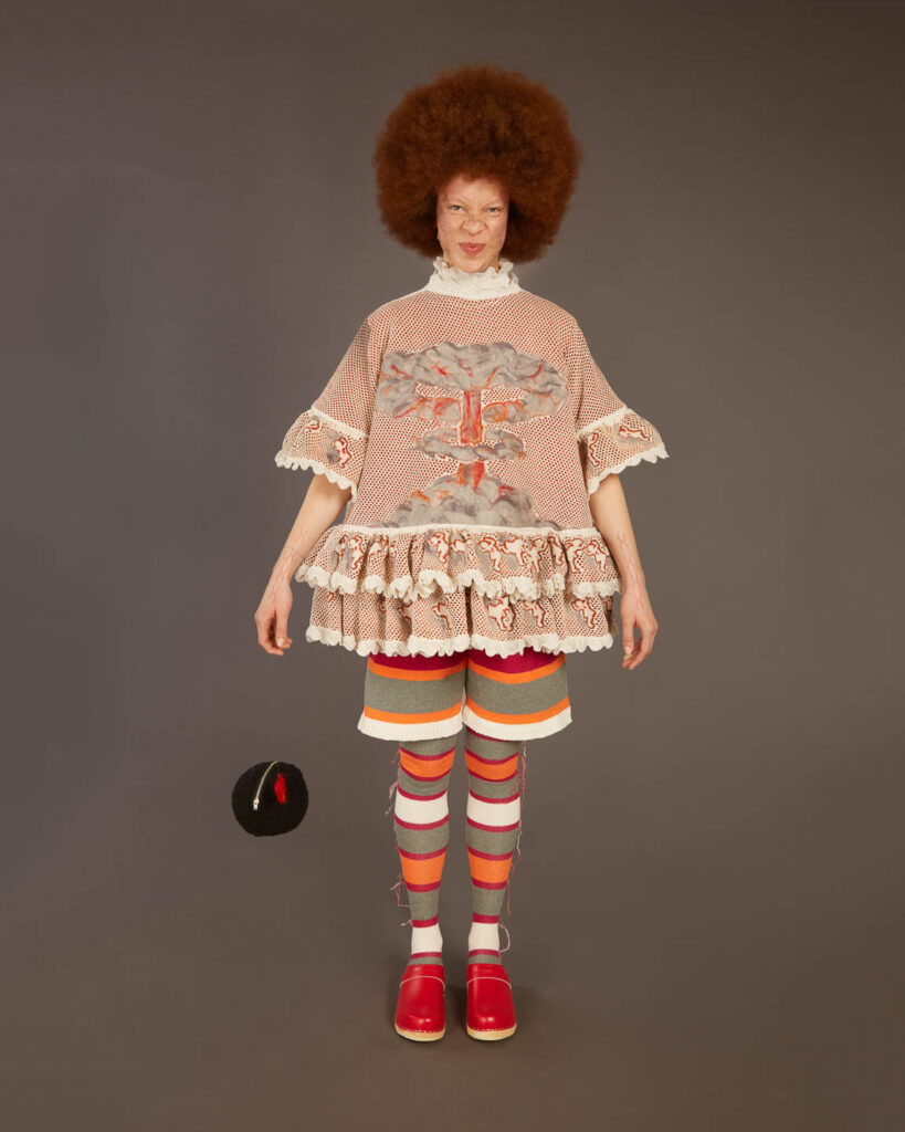 a woman standing in a room with a dress on