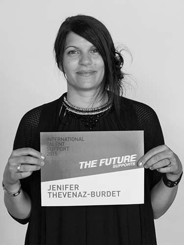 a woman holding a sign that says the future sports