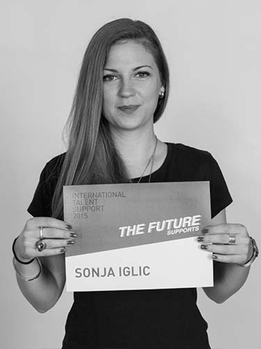 a woman holding up a sign that reads the future sanja igliic