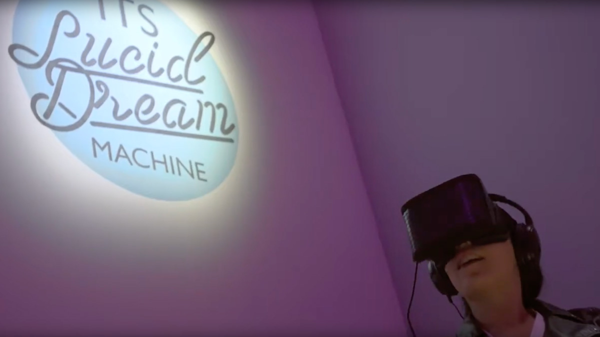 a man wearing a virtual headset in front of a sign