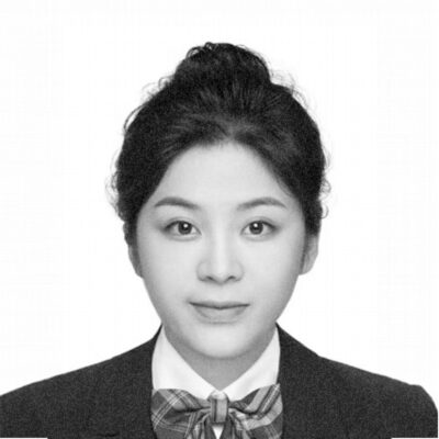 a black and white photo of a woman wearing a bow tie