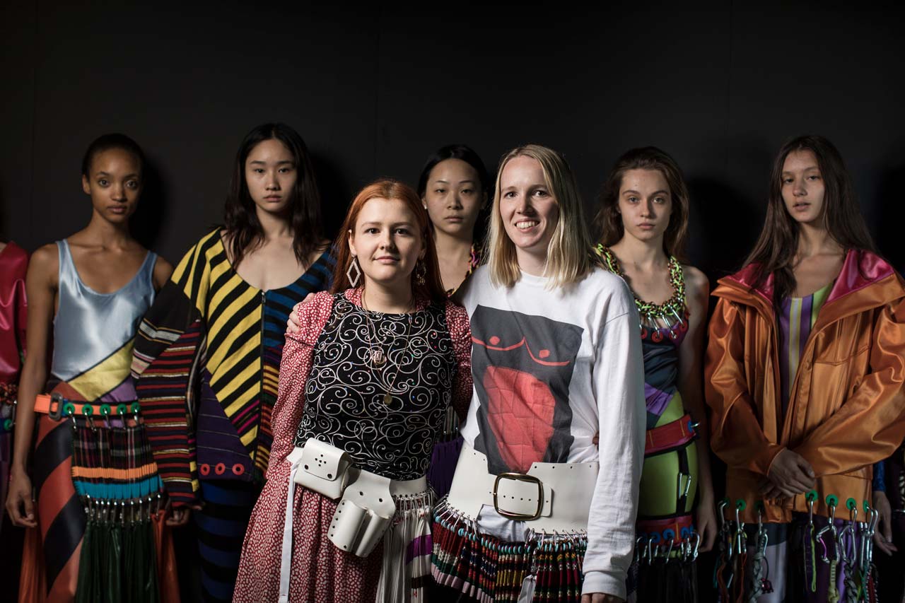 Laura Lowena and Emma Chopova pose in the ITS 2018 fashion show backstage with their winning collection