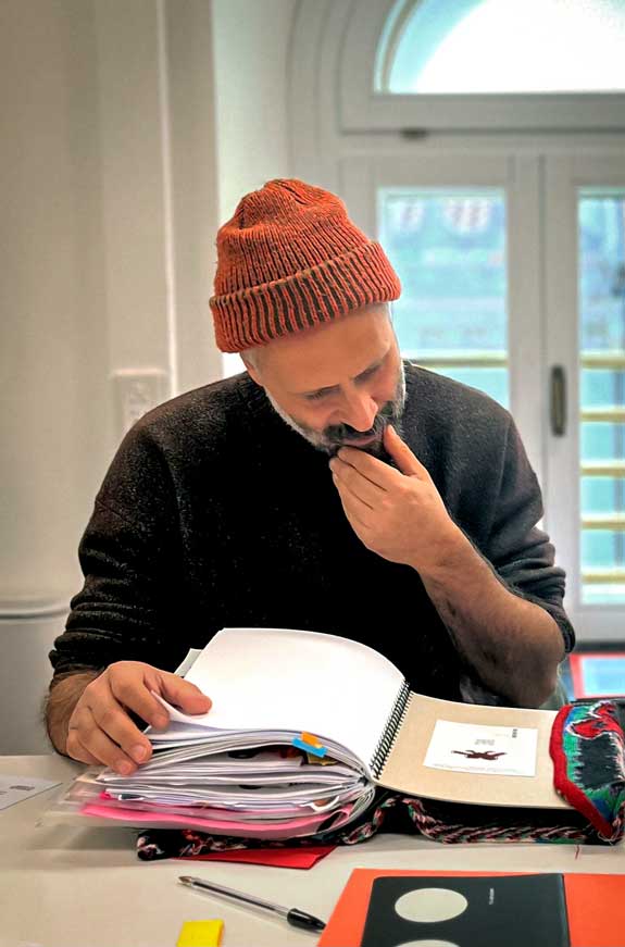 a man sitting at a table with an open book